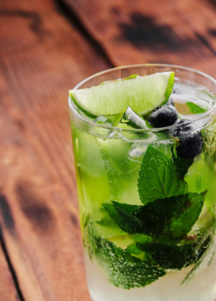 glass of fresh Mojito on wooden